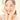 Smiling woman with clear, glowing skin using gentle skincare routine