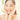 Smiling woman with clear, glowing skin using gentle skincare routine