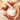 Close-up of hands dipping into a jar of white skincare cream, showing smooth application and moisturising texture