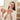 Smiling woman in white robe applying Clarity Patch while looking in bathroom mirror for acne treatment