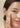 Close-up of a woman with glowing skin gently applying skincare product to her face, promoting a healthy and radiant complexion
